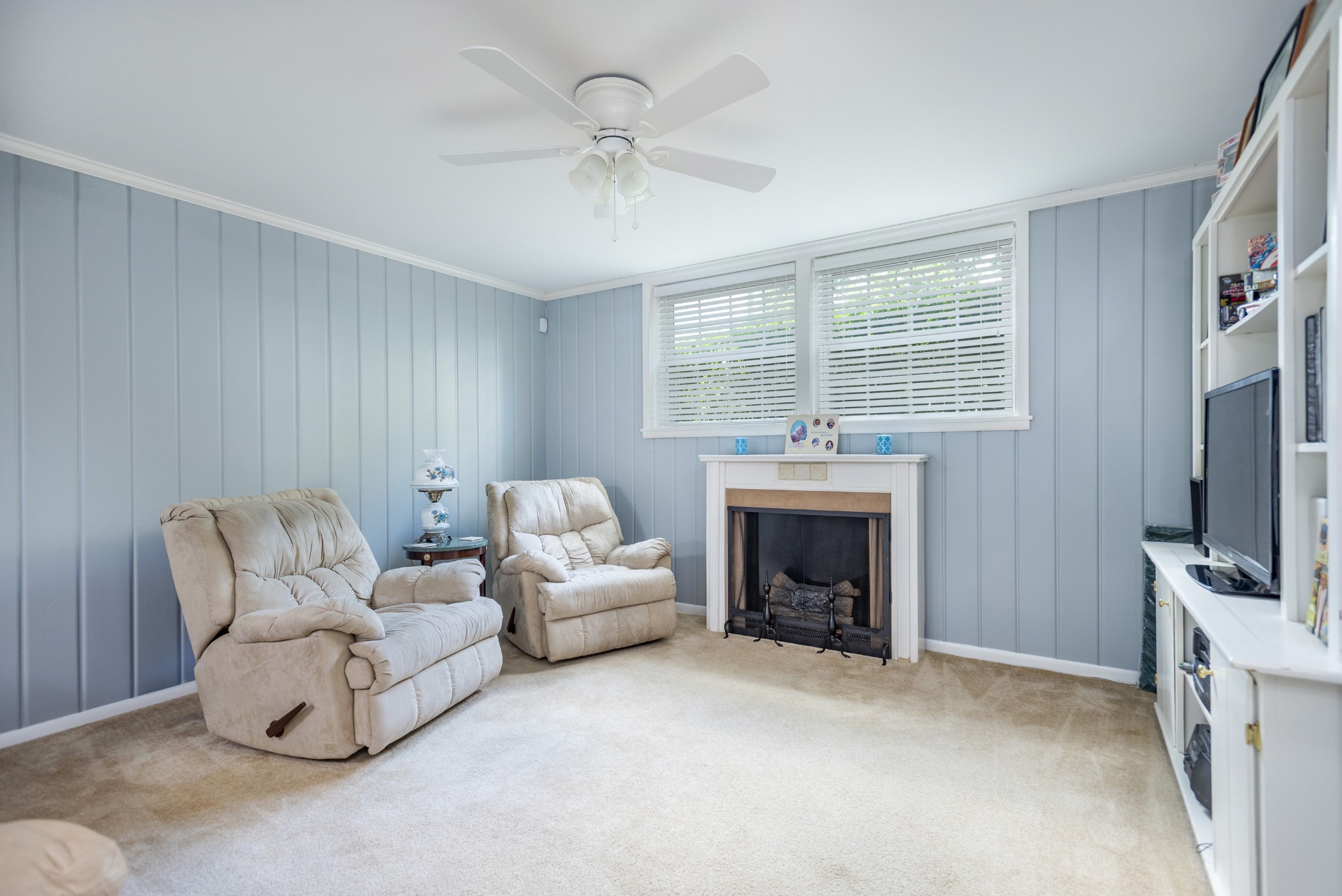 8416 Terry Lane Hermitage, TN 37076 - Photo 13 of 24 a living room with furniture a fireplace and a flat screen tv