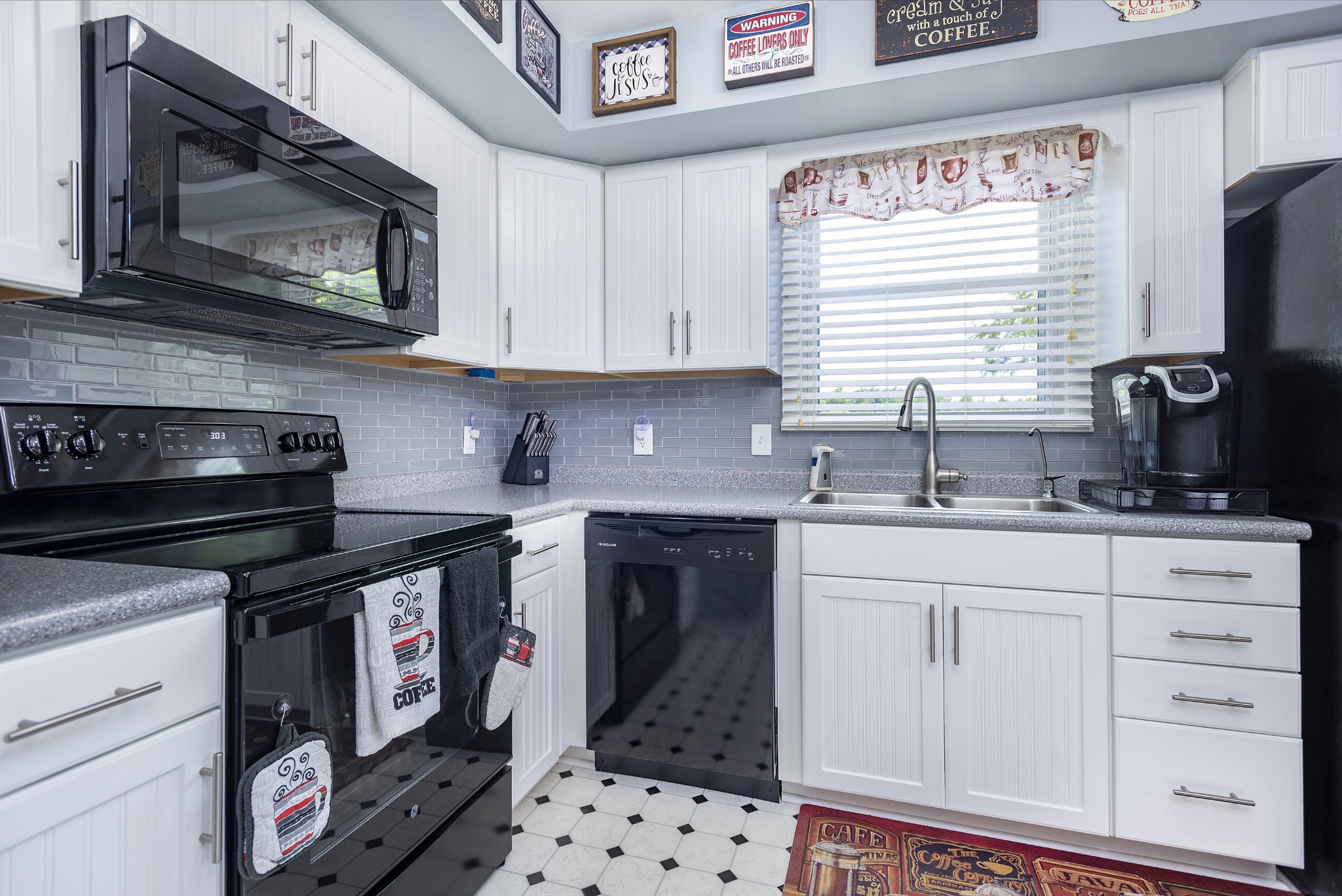 8416 Terry Lane Hermitage, TN 37076 - Photo 7 of 24 a kitchen with granite countertop a stove a sink and a microwave