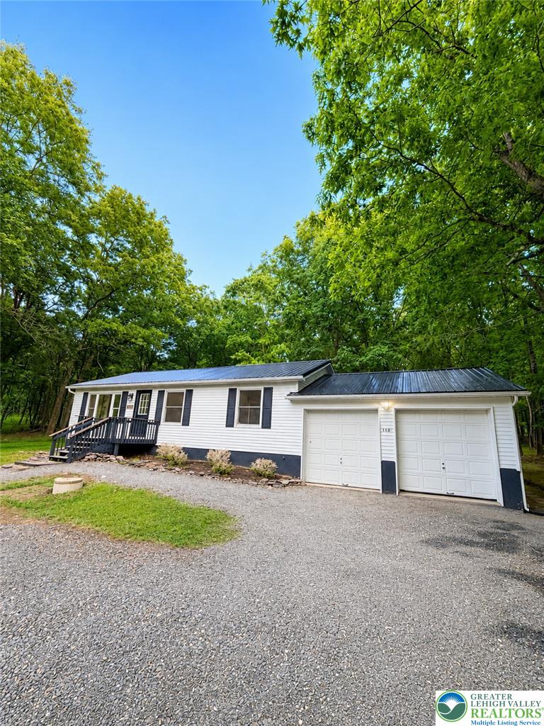 182 Mountain Road Albrightsville, PA 18210 - Photo 2 of 17 A charming country residence with a wide gravel driveway, nestled among mature trees.