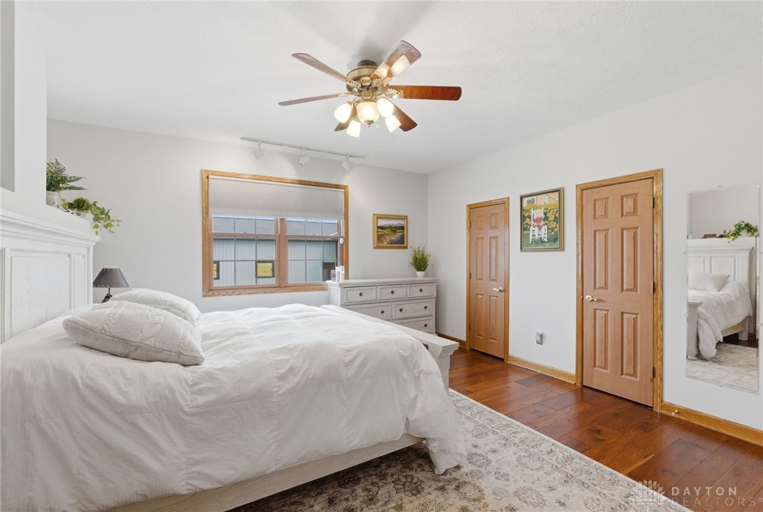 1540 Jasper Road Xenia, OH 45385 - Photo 27 of 91 This inviting bedroom features rich hardwood flooring and a ceiling fan for optimal comfort.