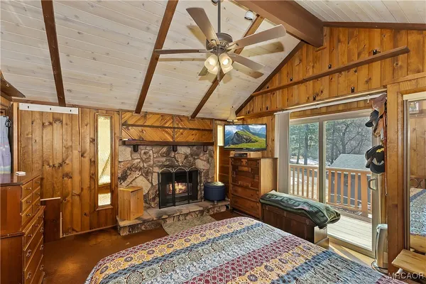 a bedroom with a bed and a fireplace