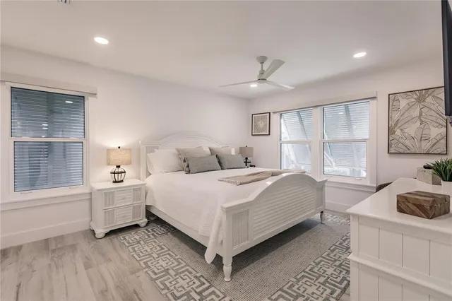 a bedroom with a large bed and a window