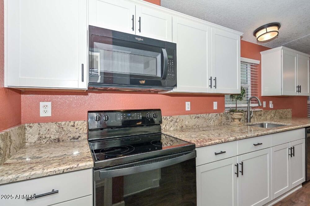 16101 North El Mirage Road, Unit 322 El Mirage, AZ 85335 - Photo 11 of 50 a kitchen with granite countertop stainless steel appliances and cabinets