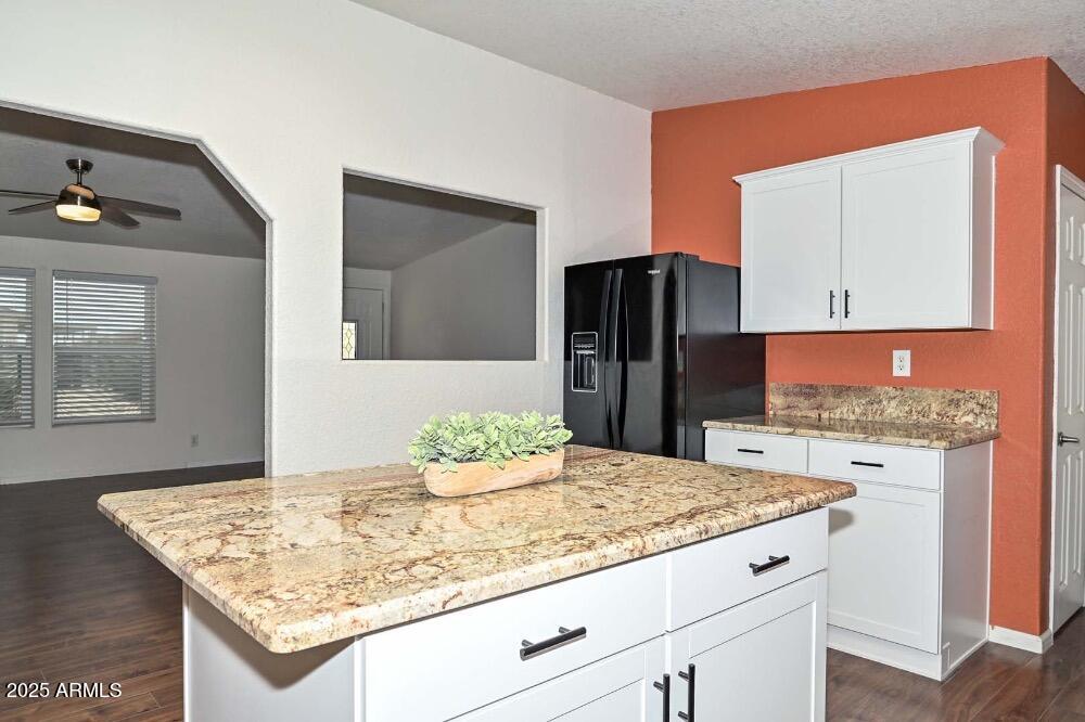 16101 North El Mirage Road, Unit 322 El Mirage, AZ 85335 - Photo 12 of 50 a kitchen with granite countertop kitchen island stainless steel appliances a sink refrigerator and stove