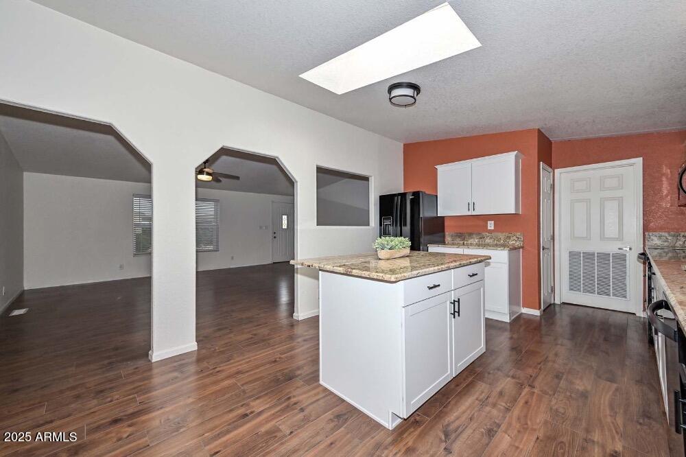 16101 North El Mirage Road, Unit 322 El Mirage, AZ 85335 - Photo 14 of 50 a kitchen with a stove and wooden floor