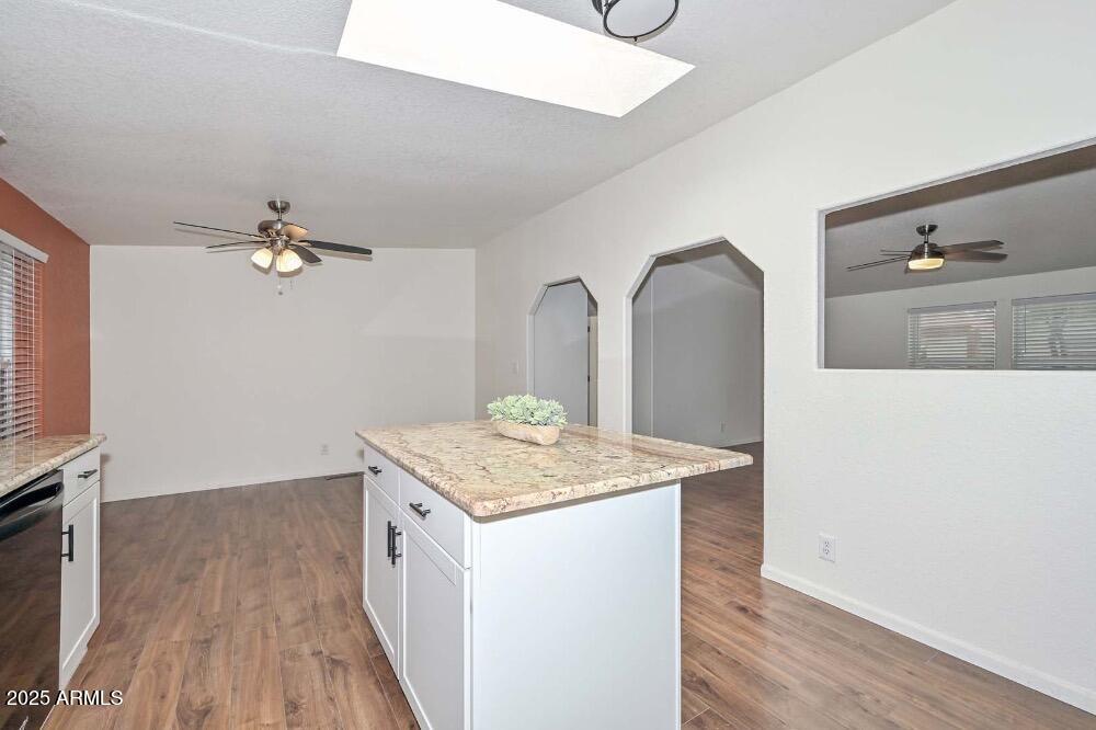16101 North El Mirage Road, Unit 322 El Mirage, AZ 85335 - Photo 15 of 50 a spacious bathroom with a granite countertop sink a mirror and vanity