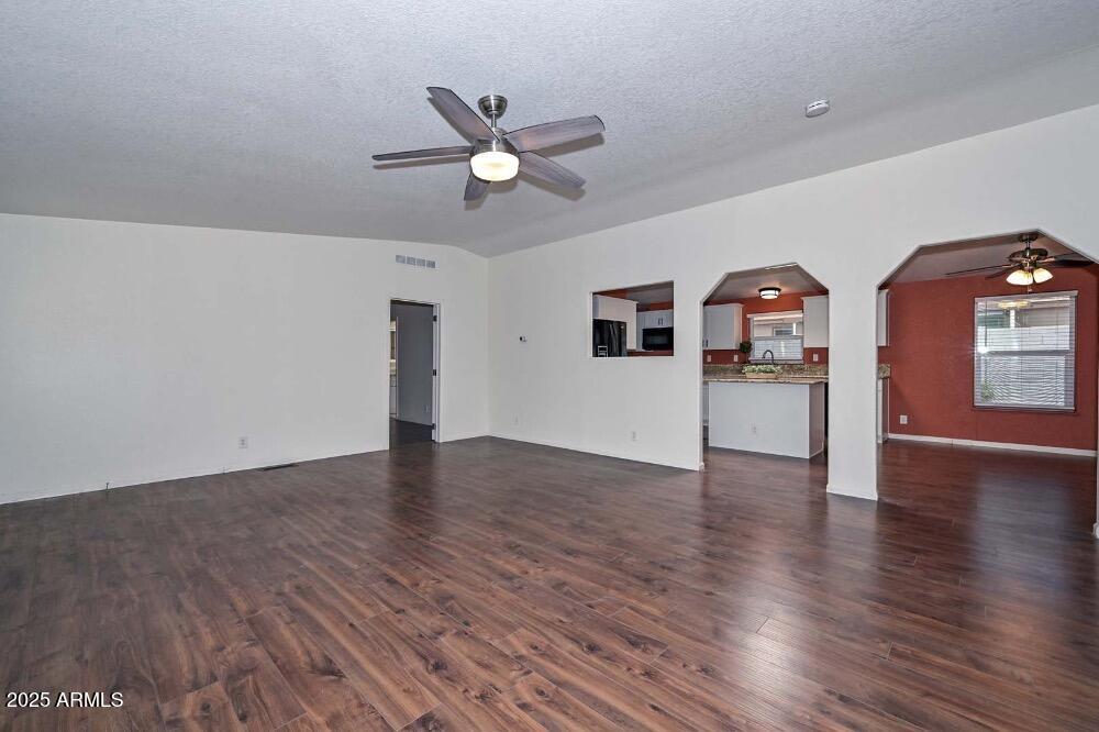 16101 North El Mirage Road, Unit 322 El Mirage, AZ 85335 - Photo 19 of 50 a view of empty room with wooden floor and ceiling fan