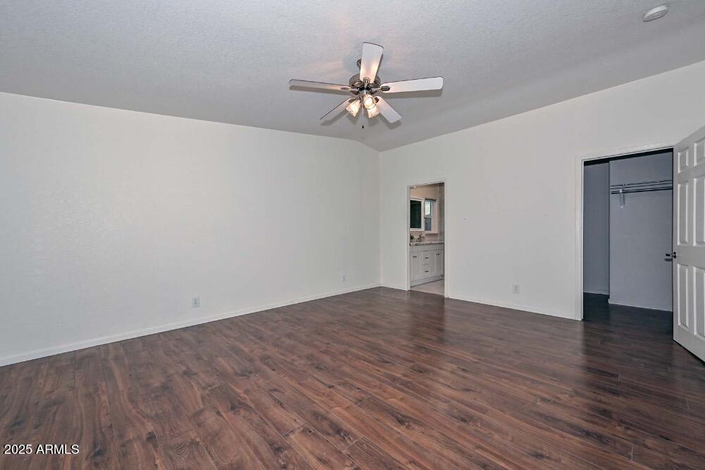 16101 North El Mirage Road, Unit 322 El Mirage, AZ 85335 - Photo 23 of 50 a view of a room with wooden floor and a ceiling fan