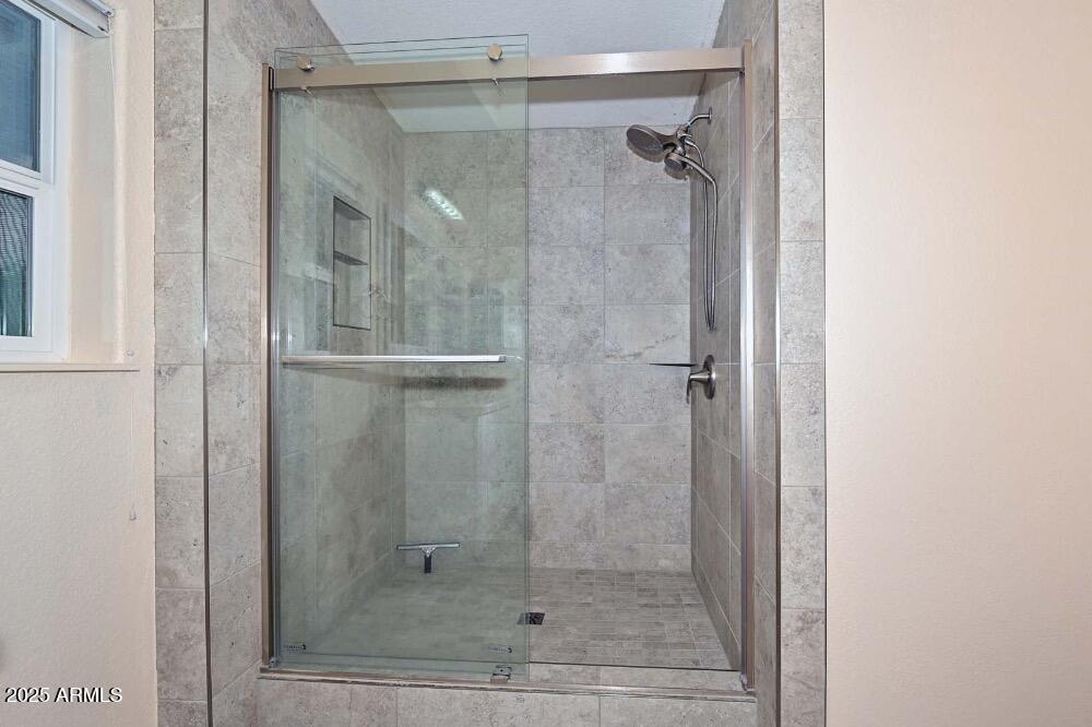 16101 North El Mirage Road, Unit 322 El Mirage, AZ 85335 - Photo 26 of 50 a bathroom with a glass shower door