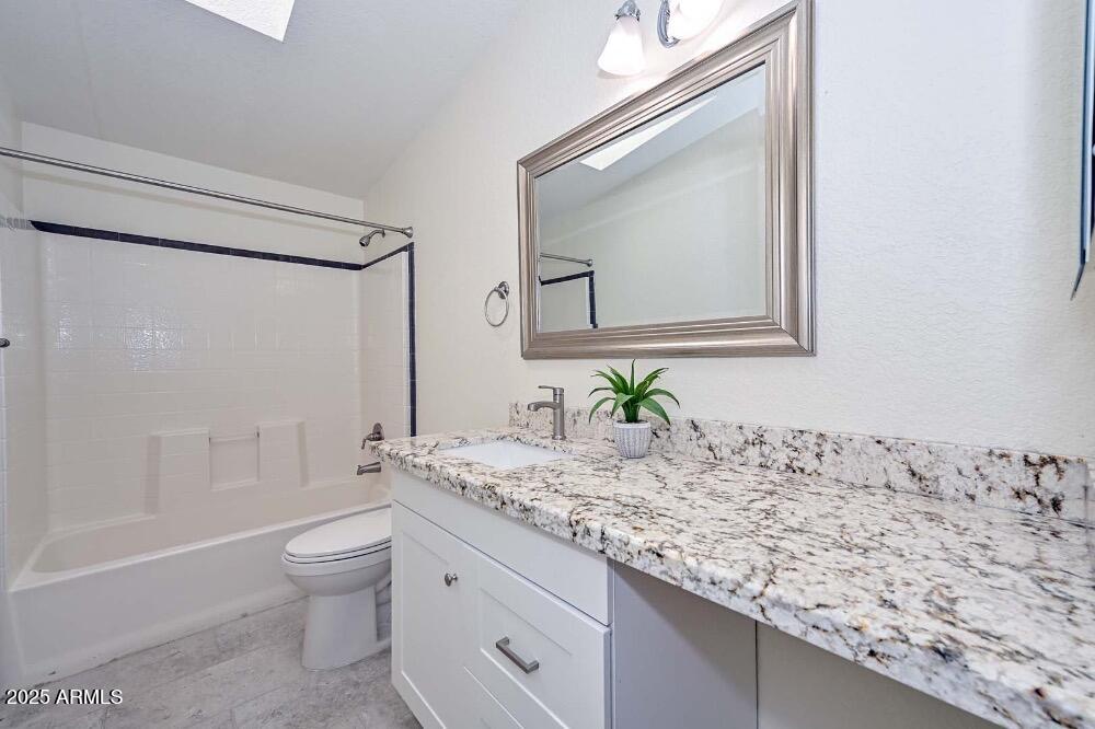 16101 North El Mirage Road, Unit 322 El Mirage, AZ 85335 - Photo 28 of 50 a bathroom with a granite countertop sink and a mirror