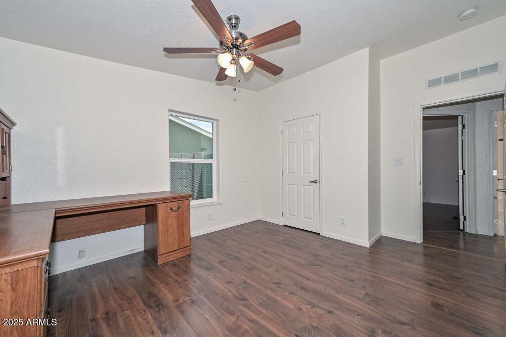 16101 North El Mirage Road, Unit 322 El Mirage, AZ 85335 - Photo 33 of 50 wooden floor in an empty room with a window