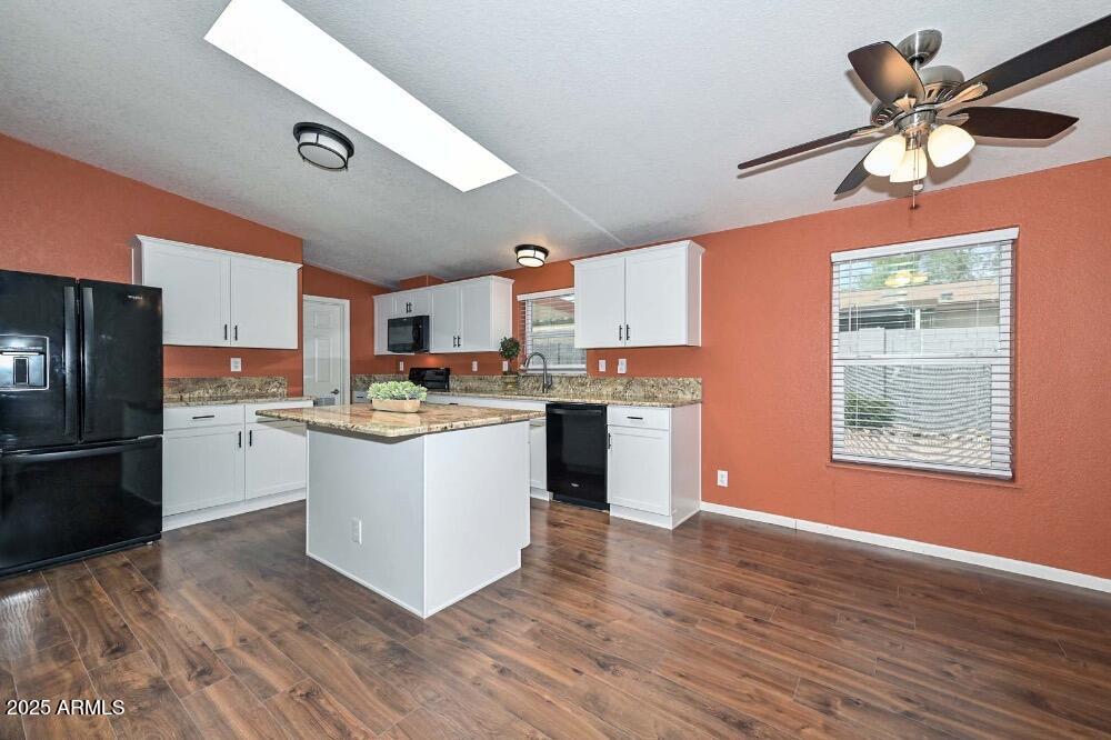 16101 North El Mirage Road, Unit 322 El Mirage, AZ 85335 - Photo 6 of 50 a kitchen with a refrigerator cabinets and wooden floor