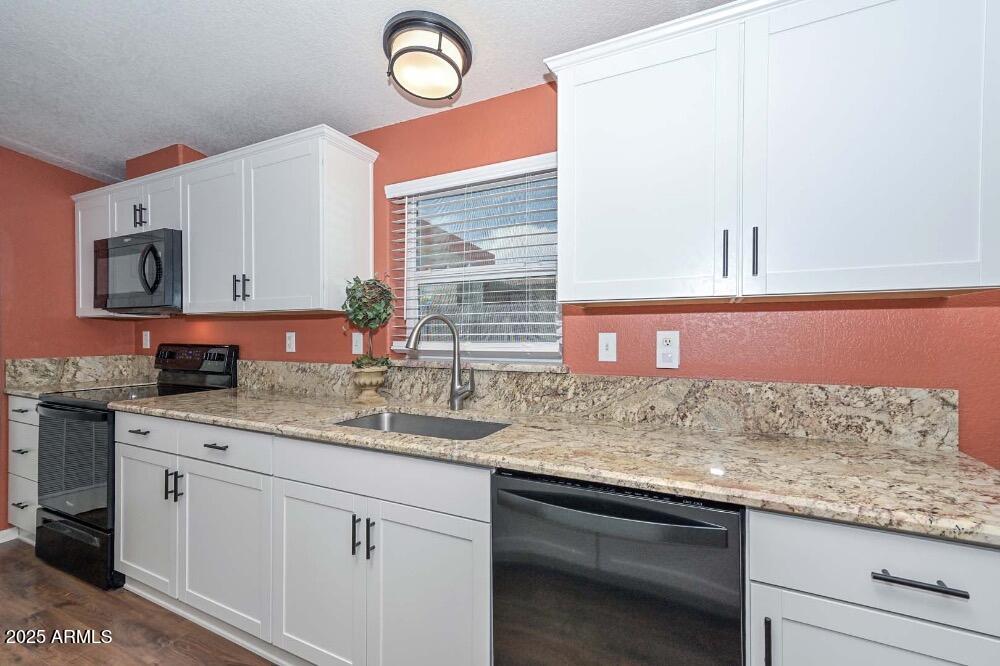 16101 North El Mirage Road, Unit 322 El Mirage, AZ 85335 - Photo 8 of 50 a kitchen with stainless steel appliances granite countertop a sink and cabinets
