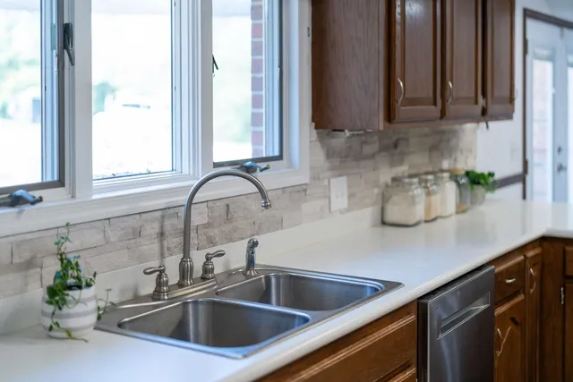 a living room with furniture and floor to ceiling windows