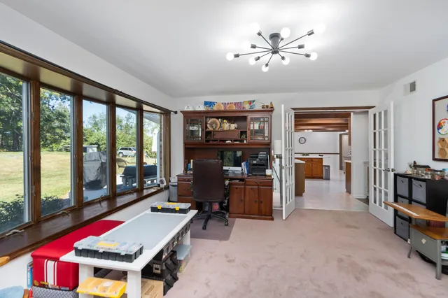 a view of patio with chairs and table under an umbrella
