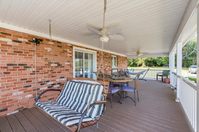 a view of a roof deck with table and chairs