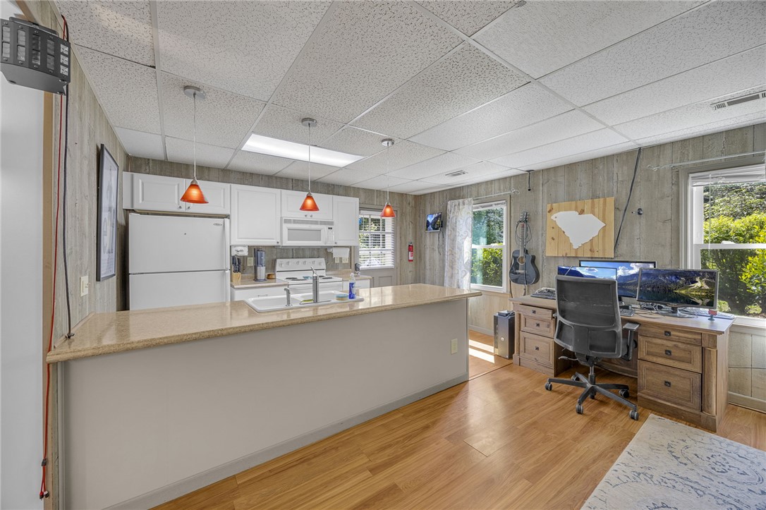 1002 Berkeley Drive Clemson, SC 29631 - Photo 15 of 23 This versatile space combines a functional kitchen with a dedicated workspace, offering practical living.