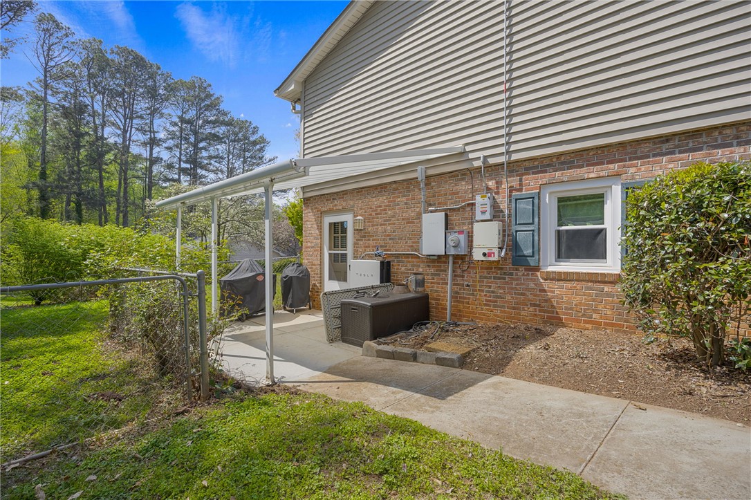 1002 Berkeley Drive Clemson, SC 29631 - Photo 20 of 23 This residence features a patio for outdoor enjoyment, complemented by a serene wooded backdrop.