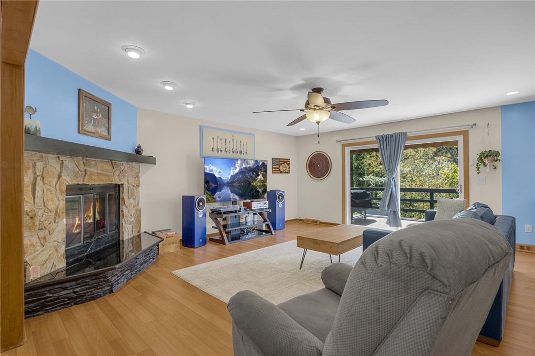 1002 Berkeley Drive Clemson, SC 29631 - Photo 5 of 23 This living area features a warm fireplace and sliding doors that open to scenic outdoor views.