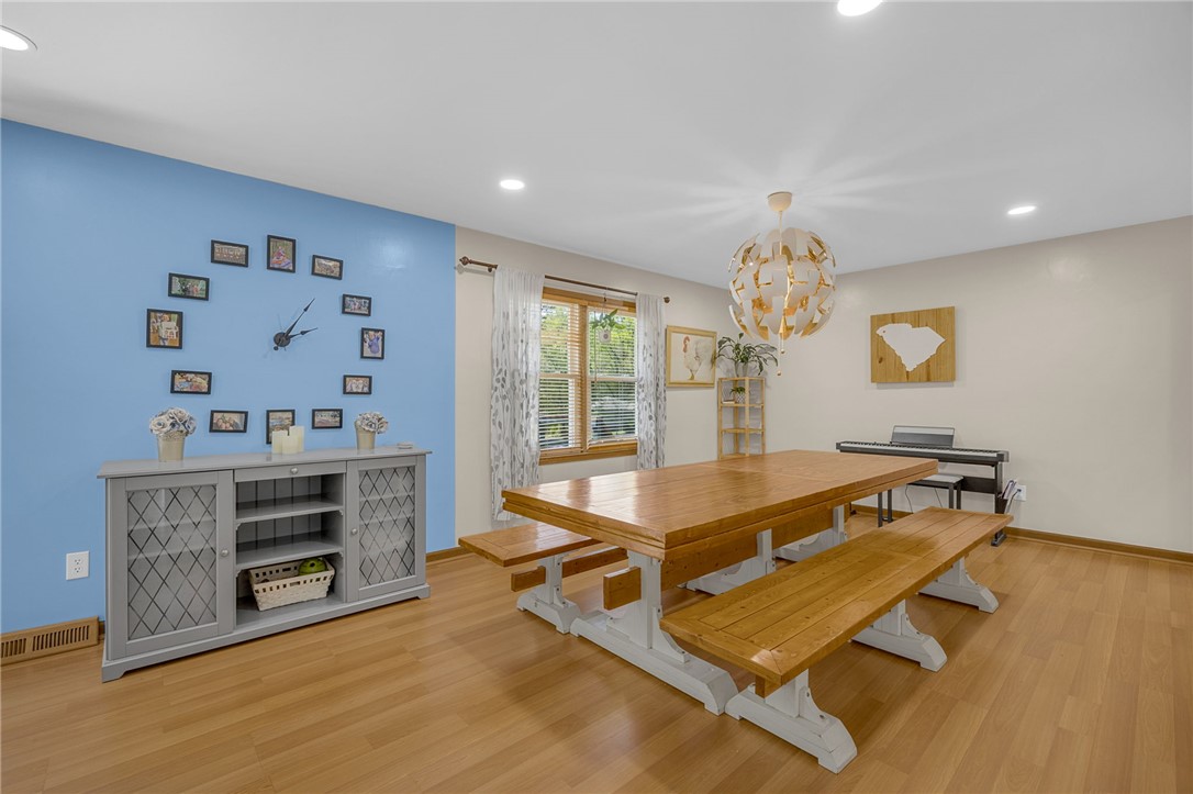 1002 Berkeley Drive Clemson, SC 29631 - Photo 6 of 23 This dining area features hardwood flooring and recessed lighting, offering a bright and functional space.