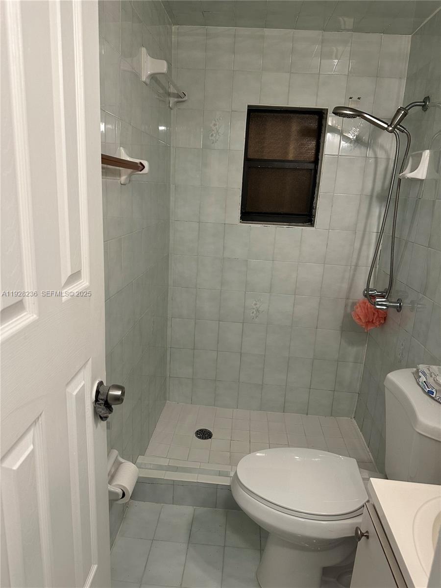 85 West 55th Street, Unit EFFICI Hialeah, FL 33012 - Photo 3 of 6 a bathroom with a toilet and a shower