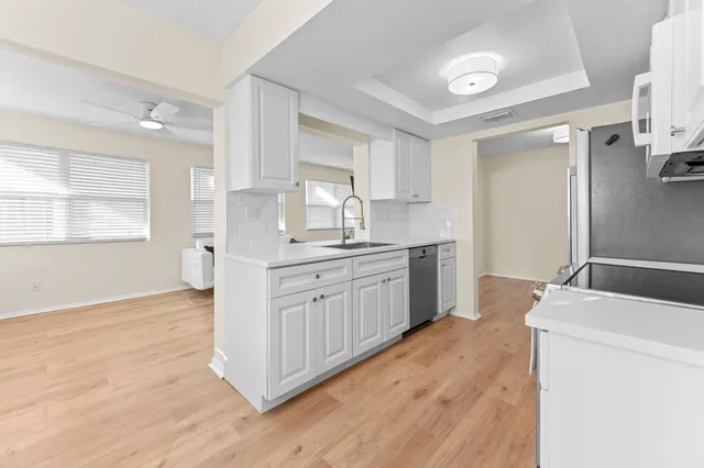 a kitchen with a sink window and cabinets