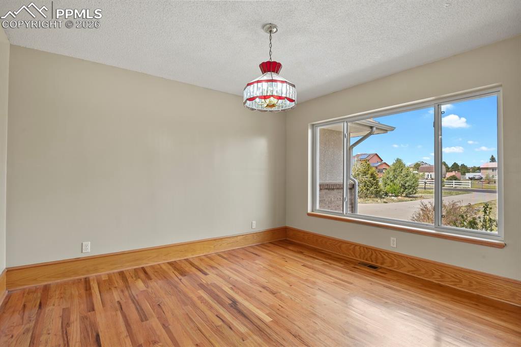 11505 Salinas Road Peyton, CO 80831 - Photo 13 of 37 a view of an empty room with wooden floor and a window