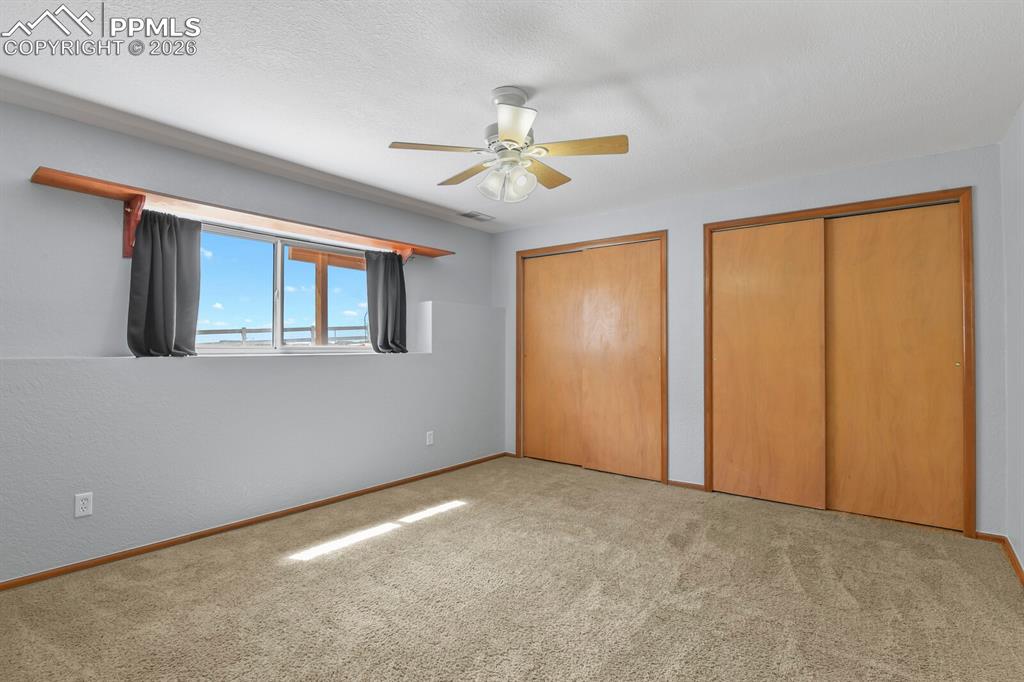 11505 Salinas Road Peyton, CO 80831 - Photo 16 of 37 a view of an empty room with window and chandelier fan