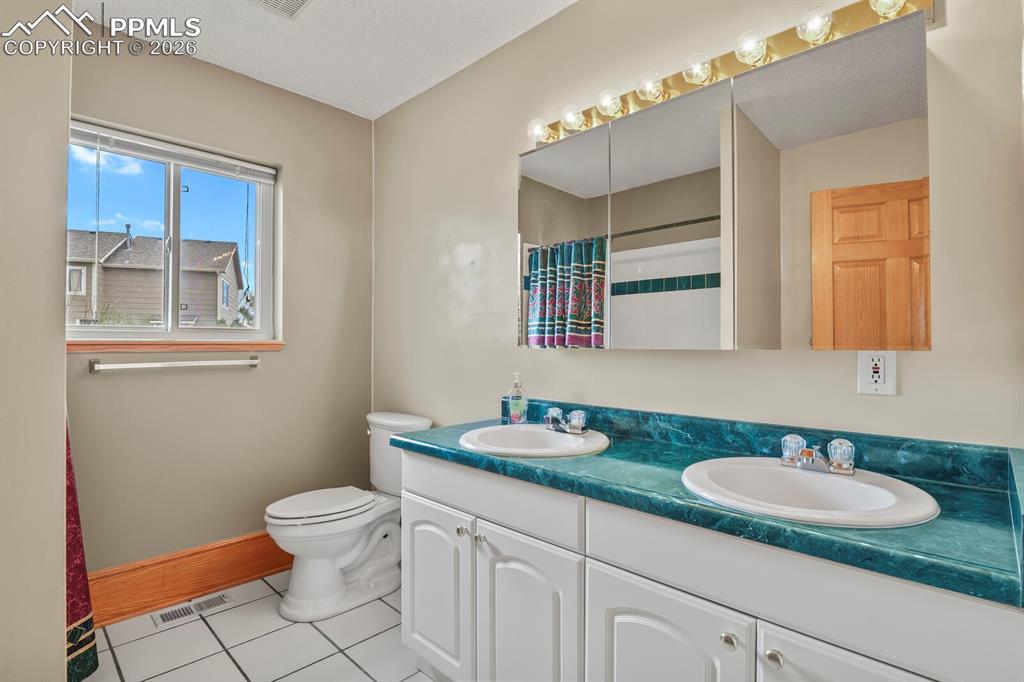 11505 Salinas Road Peyton, CO 80831 - Photo 17 of 37 a bathroom with a granite countertop sink and a mirror