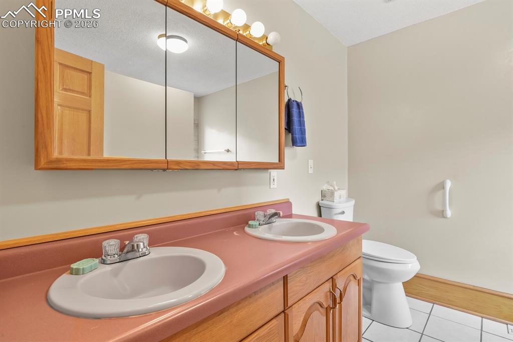 11505 Salinas Road Peyton, CO 80831 - Photo 19 of 37 a bathroom with a sink and a mirror