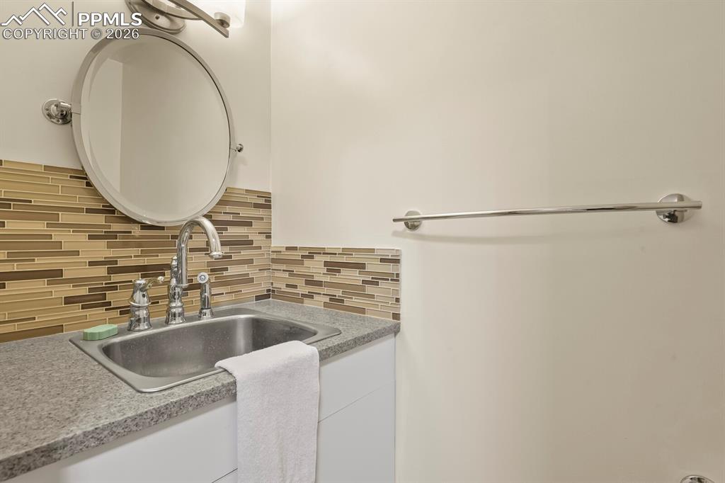 11505 Salinas Road Peyton, CO 80831 - Photo 22 of 37 Off Laundry Room is a 1/2 Bath with Deep Sink