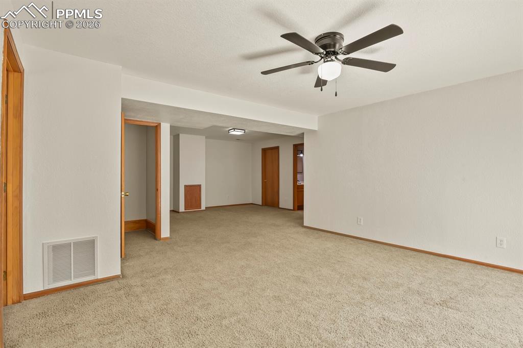 11505 Salinas Road Peyton, CO 80831 - Photo 24 of 37 Family room with ceiling fan and light colored carpet