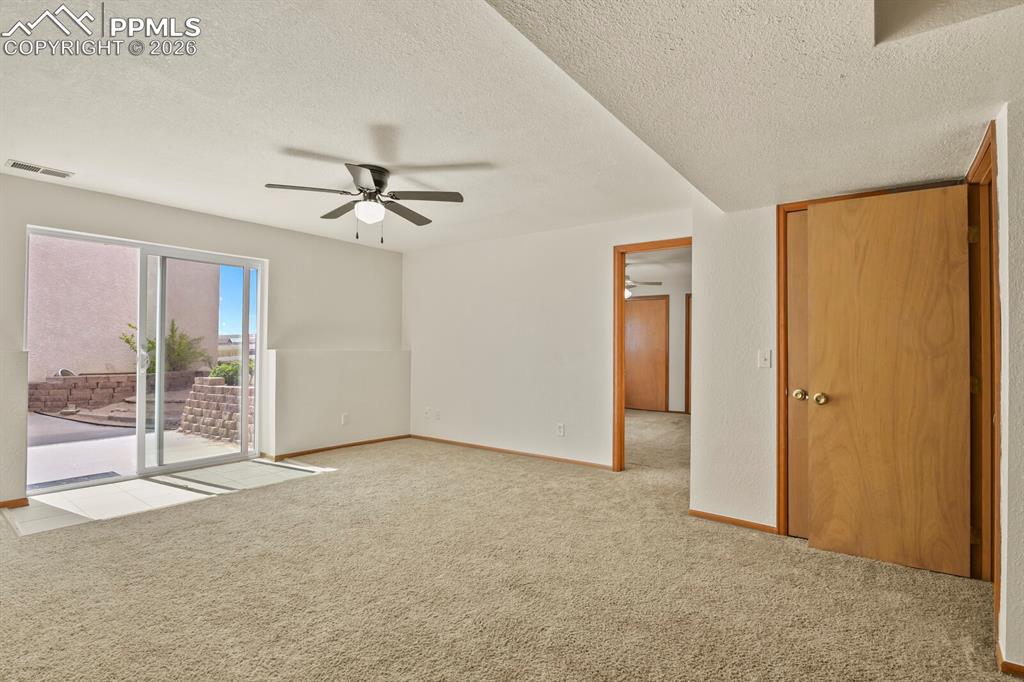 11505 Salinas Road Peyton, CO 80831 - Photo 25 of 37 Family room featuring ceiling fan and Walk Out to Rear Yeard and Rear Detached Building