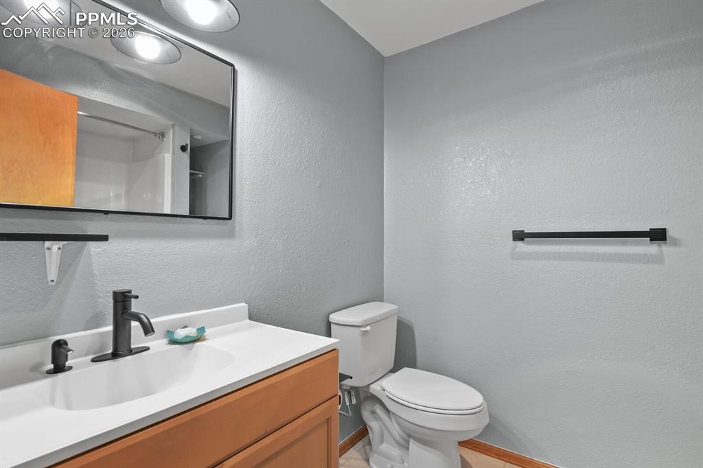 11505 Salinas Road Peyton, CO 80831 - Photo 28 of 37 a bathroom with a sink a toilet and mirror