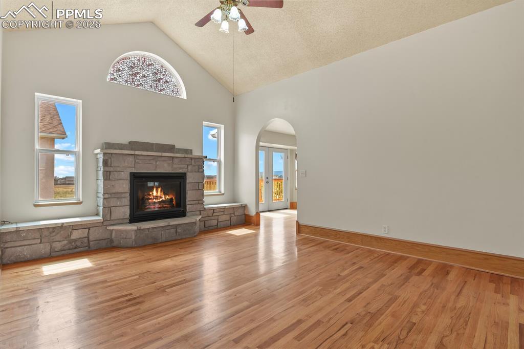11505 Salinas Road Peyton, CO 80831 - Photo 4 of 37 a view of an empty room with a fireplace and wooden floor