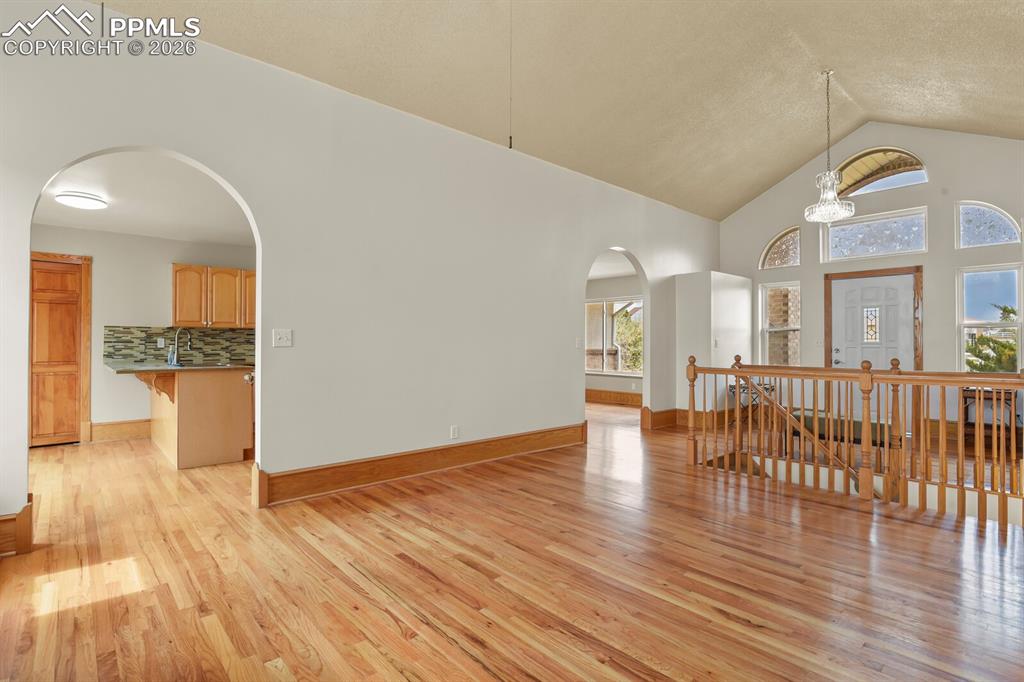 11505 Salinas Road Peyton, CO 80831 - Photo 5 of 37 Living room Looking Into Kithen with arched walkways, and a high ceiling