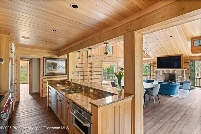 a kitchen with stainless steel appliances granite countertop a stove and a wooden floors