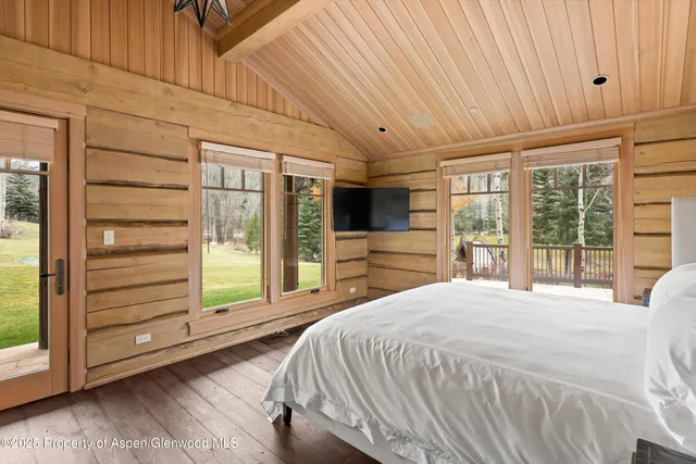a bedroom with a bed and large window