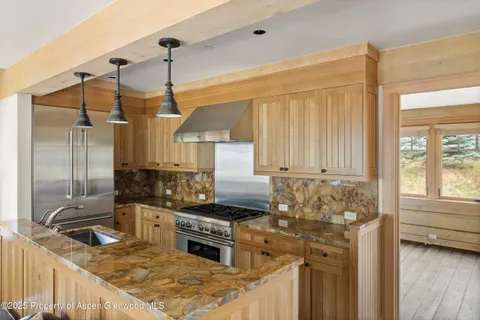 a kitchen with sink refrigerator and stove