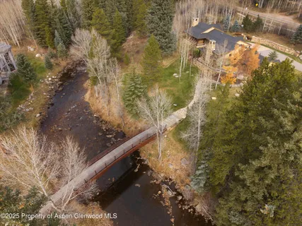 a view of swimming pool with a yard and lake view