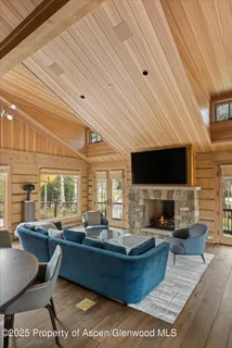 a living room with fireplace furniture and a flat screen tv