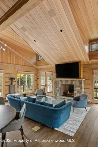 a living room with fireplace furniture and a flat screen tv