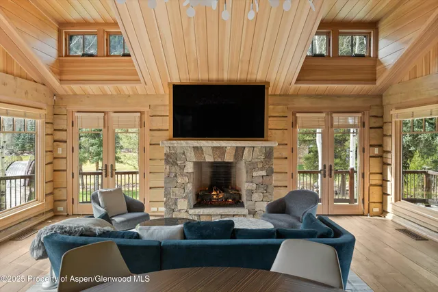 a living room with furniture fireplace and flat screen tv