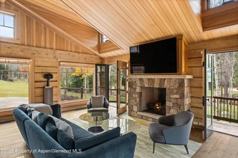 a living room with fireplace furniture and a flat screen tv