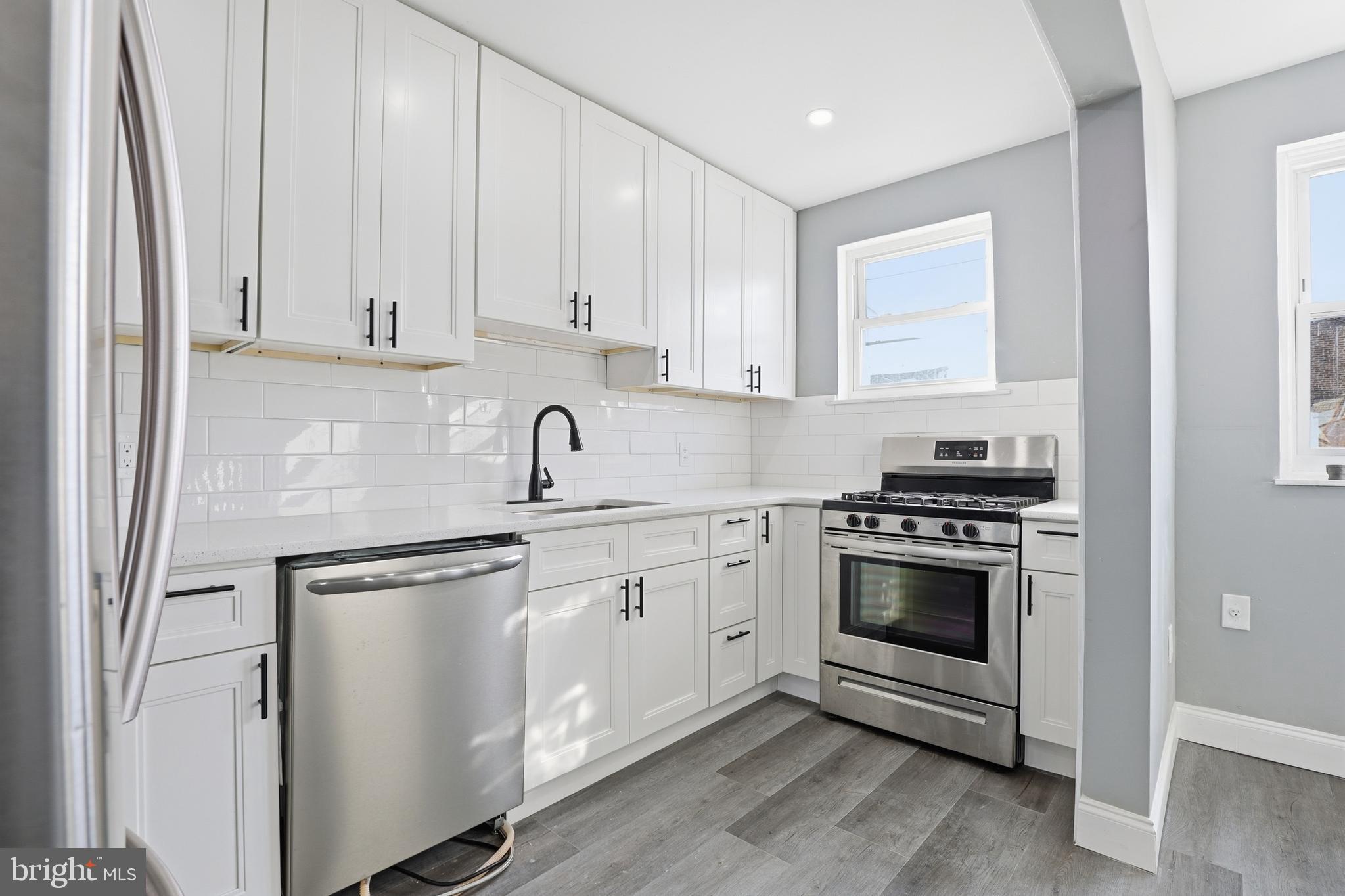 a kitchen with cabinets appliances and a window