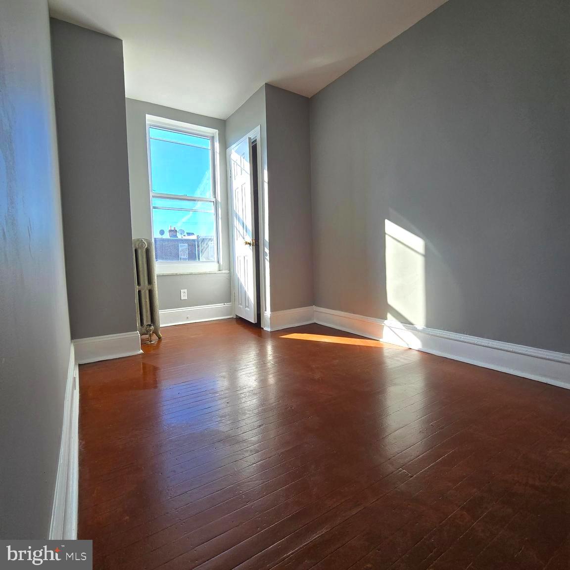 2634 South Daggett Street Philadelphia, PA 19142 - Photo 20 of 28 a view of an empty room with wooden floor and a window
