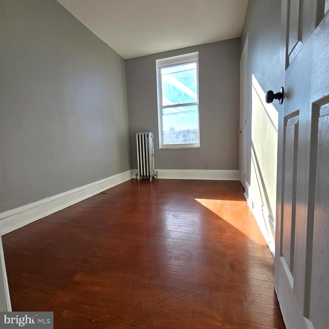 2634 South Daggett Street Philadelphia, PA 19142 - Photo 21 of 28 an empty room with wooden floor and windows