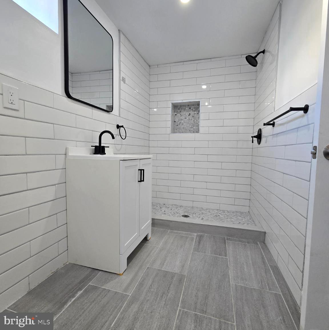 2634 South Daggett Street Philadelphia, PA 19142 - Photo 23 of 28 a bathroom with a sink and mirror