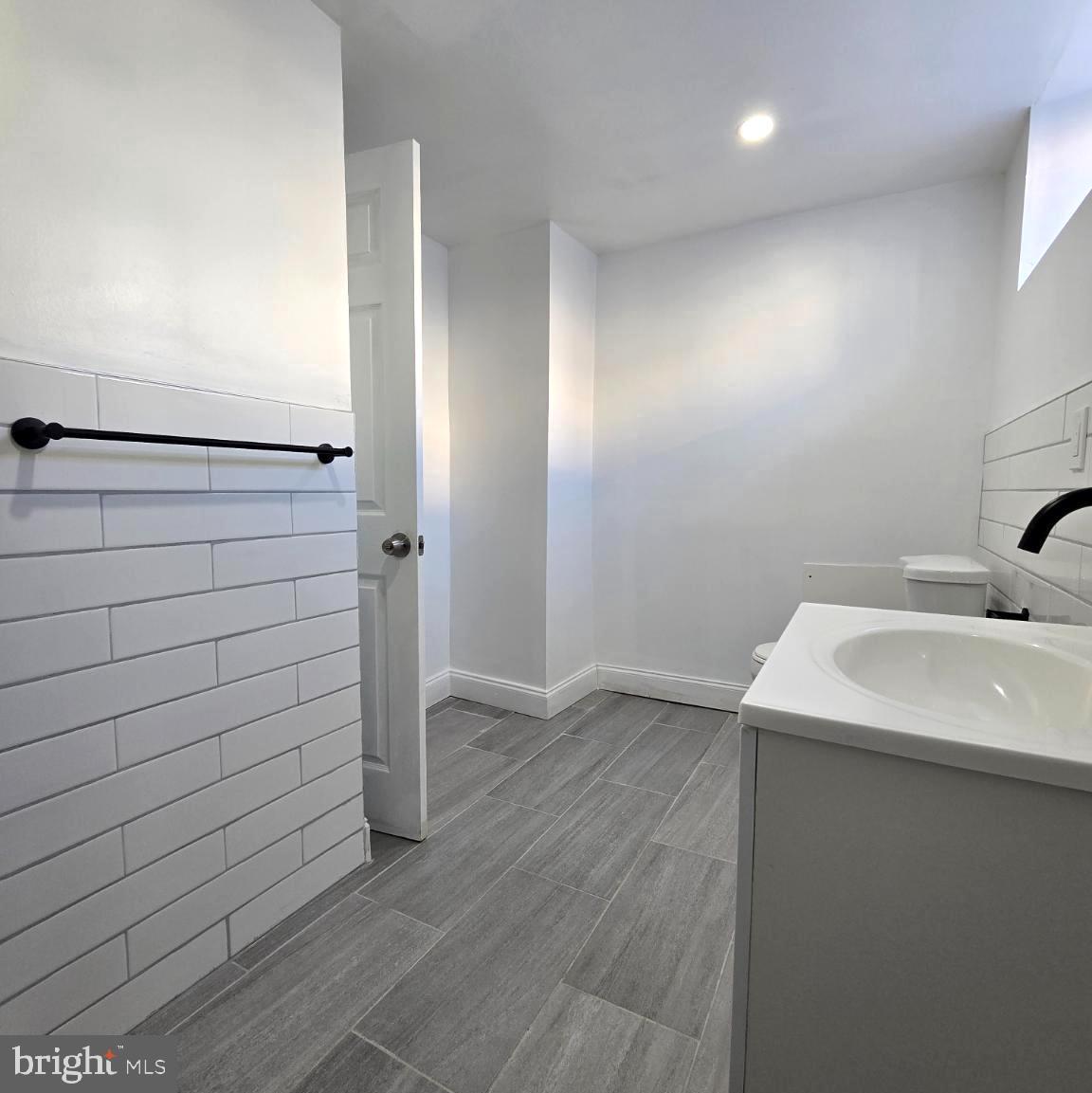 2634 South Daggett Street Philadelphia, PA 19142 - Photo 25 of 28 a bathroom with a sink and shower
