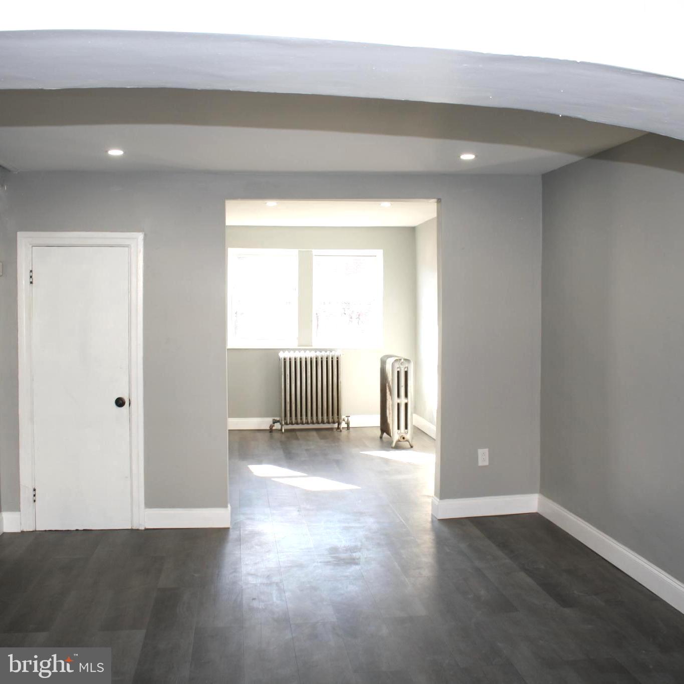 2634 South Daggett Street Philadelphia, PA 19142 - Photo 5 of 28 a view of an empty room with wooden floor and a window